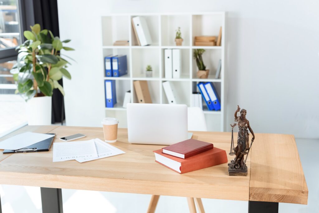 lawyer workplace with themis sculpture in modern office